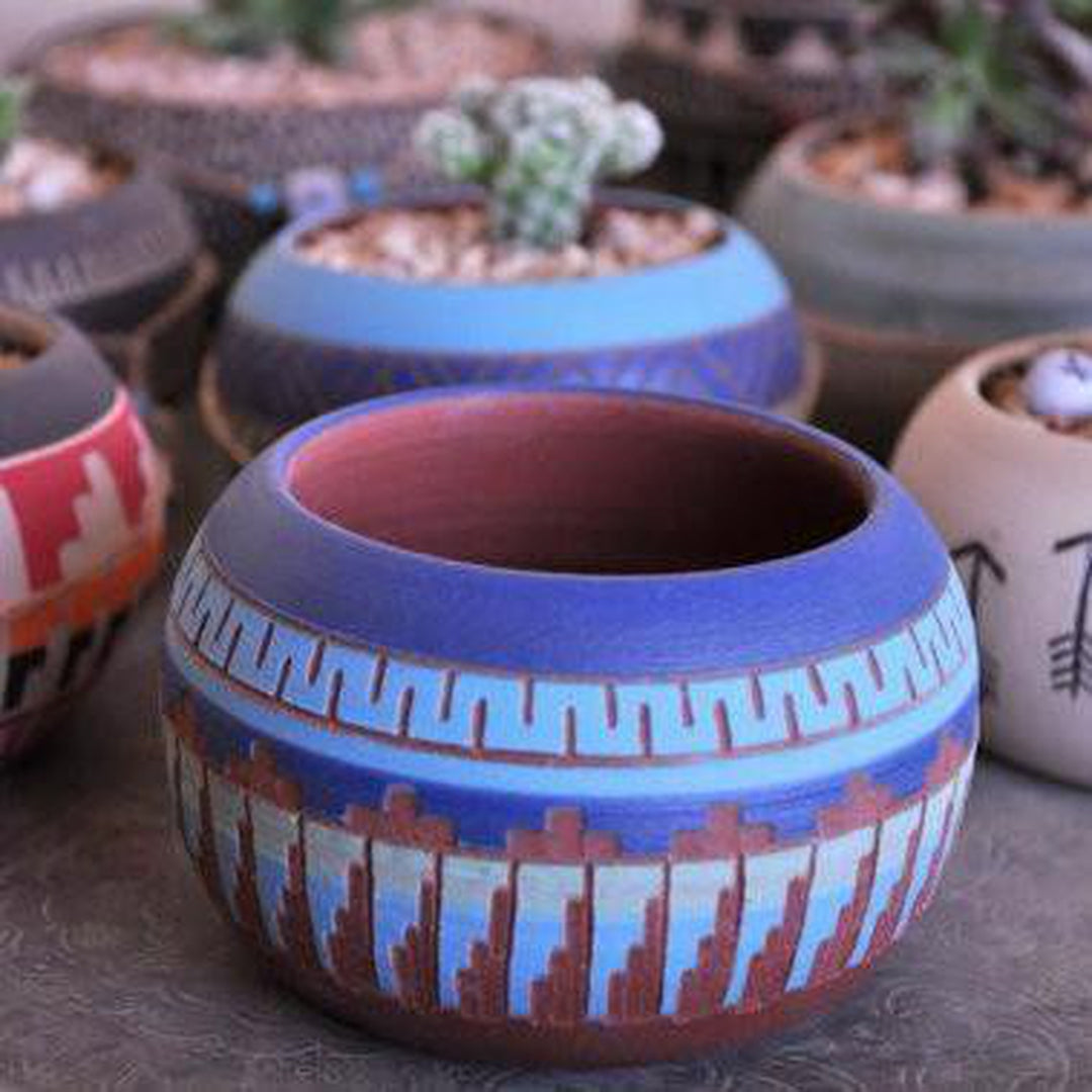 Handcrafted clay pots with desert and turquoise hues, featuring Native American-inspired Aztec and geometric patterns, durable and ideal for modern or eclectic interiors. Magnolia Lane 1.