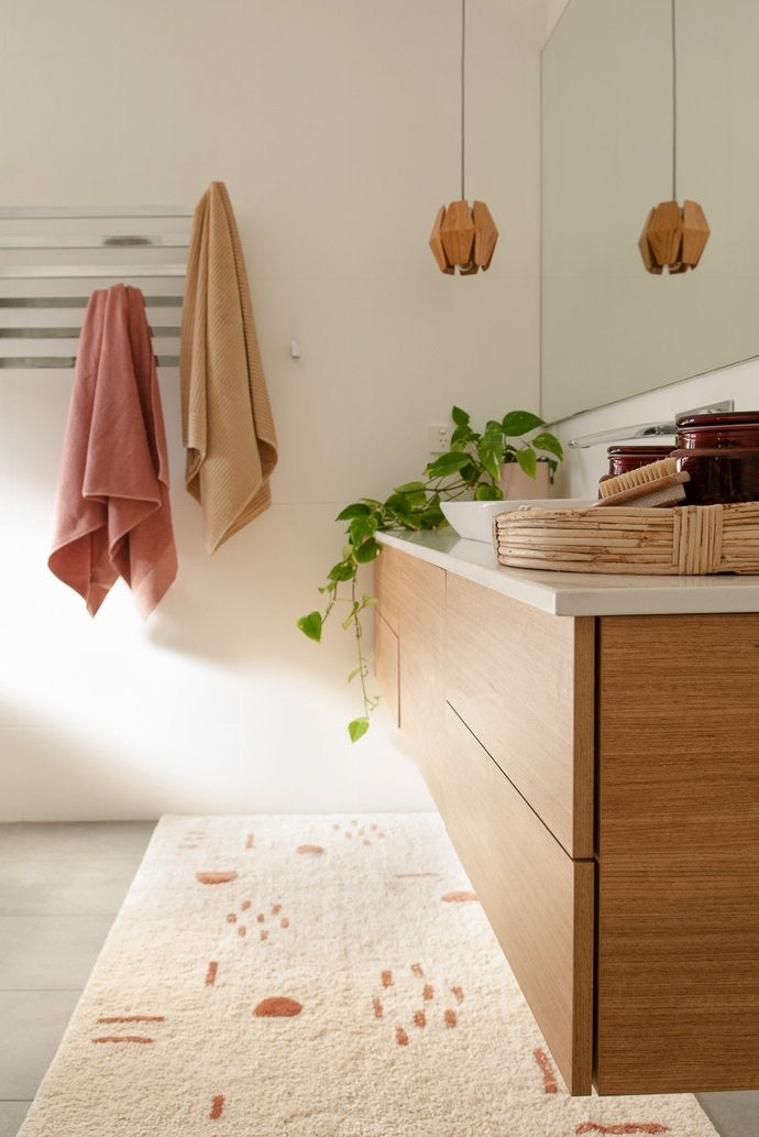 Nomad XL Bath Runner – handwoven, plush bath mat in neutral tones for luxurious bathroom or home accent decor. Styled beautifully in this modern bathroom.