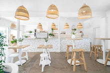 Load image into Gallery viewer, Handmade reclaimed elm wood barstool with bleached finish, featuring natural variations for a unique coastal or villa style. By Uniwqa Collections, sold by Magnolia Lane Australia wide delivery. Styled in this beautiful restaurant.ommercial