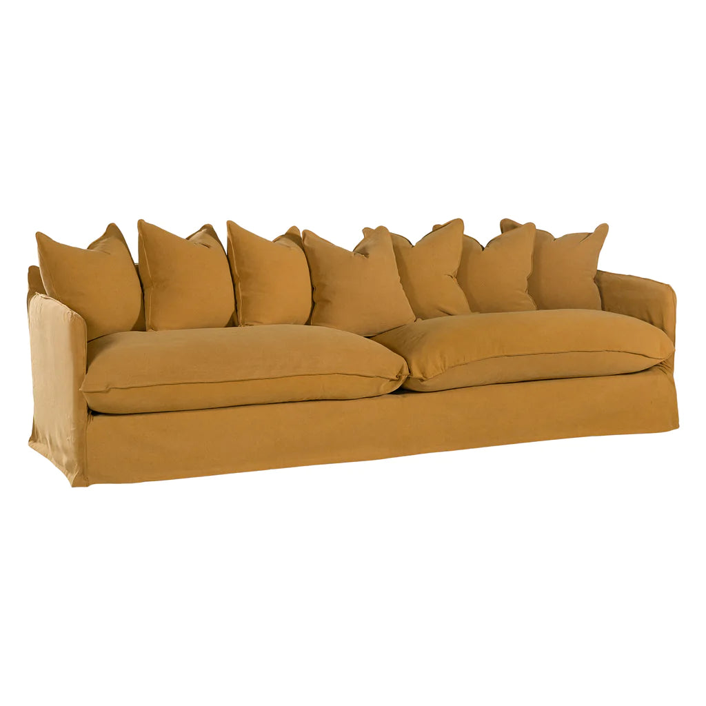 Singita Four Seater Sofa by Uniqwa with hardwood frame, feather-filled cushions and removable slipcovers in luxury linen in ochre.