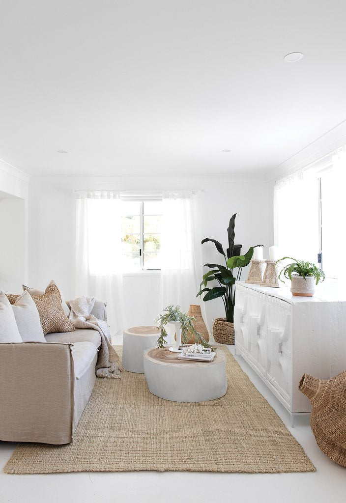White Trunk Coffee Table in a coastal living room with white sofas and woven furniture