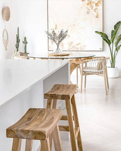 Kusina Barstool by Uniqwa Collections, crafted from solid reclaimed teak with a sleek sanded finish. Featuring natural timber grains and a curved seat, this durable and elegant bar stool adds character to dining spaces, restaurants, or bars. Modern Coastal Home 2.