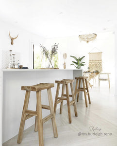 Kusina Barstool by Uniqwa Collections, crafted from solid reclaimed teak with a sleek sanded finish. Featuring natural timber grains and a curved seat, this durable and elegant bar stool adds character to dining spaces, restaurants, or bars. Modern Coastal Home 1.